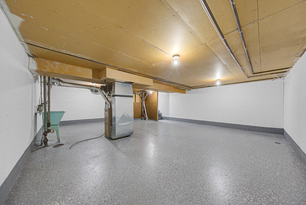 the interior of a garage with a heater in the middle