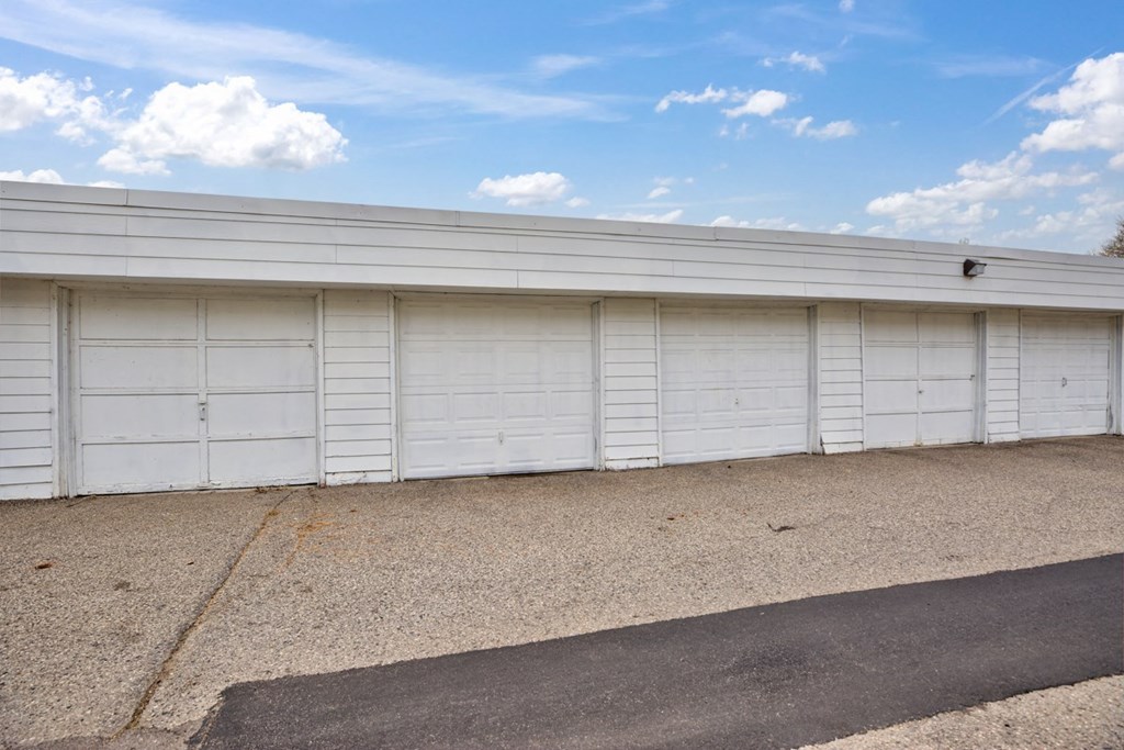 the side of a garage with white garage doors