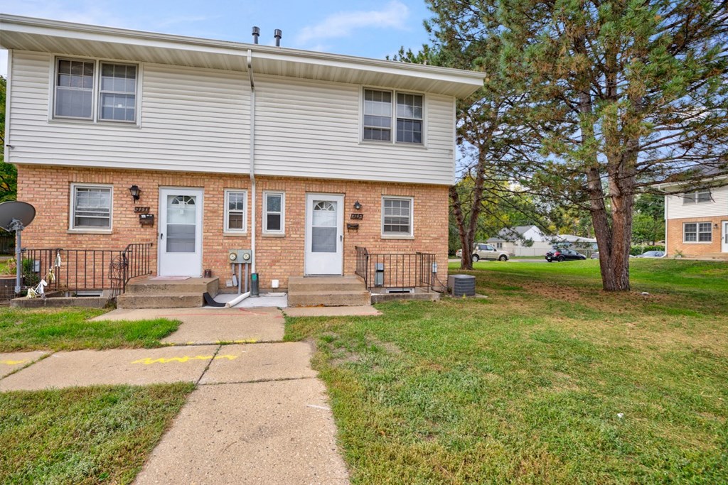 a white house with a sidewalk in front of it
