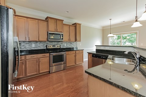 a kitchen with wooden cabinets and stainless steel appliances
