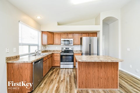 A kitchen with wooden cabinets and a countertop.