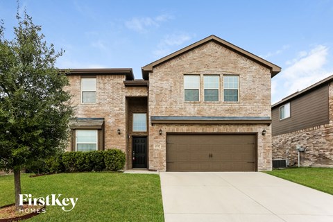 a large brick house with a garage door
