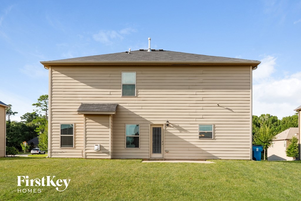 A beige house with the words "FirstKey Homes" on the bottom left.
