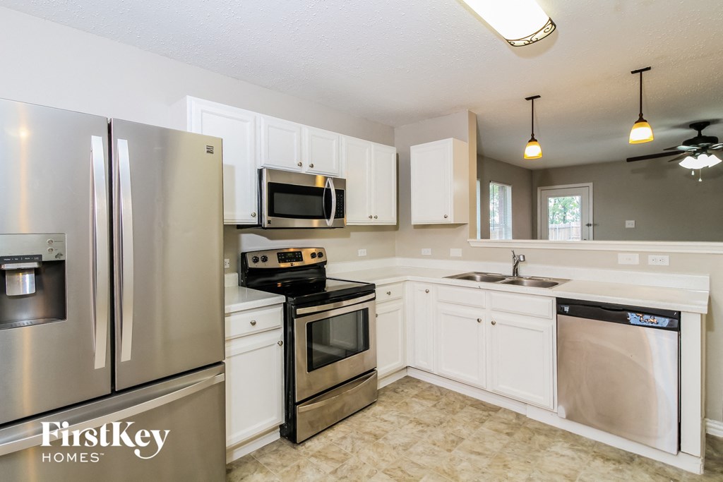 A kitchen with a FirstKey Homes logo.
