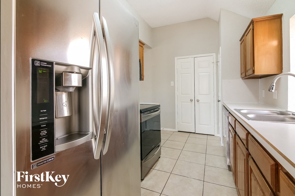 the kitchen is clean and ready to use with stainless steel appliances