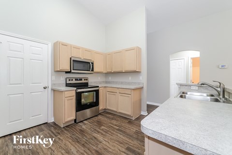A kitchen with wooden cabinets and a white countertop.