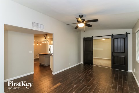 the living room and dining room with a sliding barn door