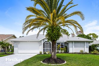 a palm tree in front of a house