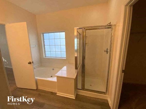 a bathroom with a tub and a shower in it