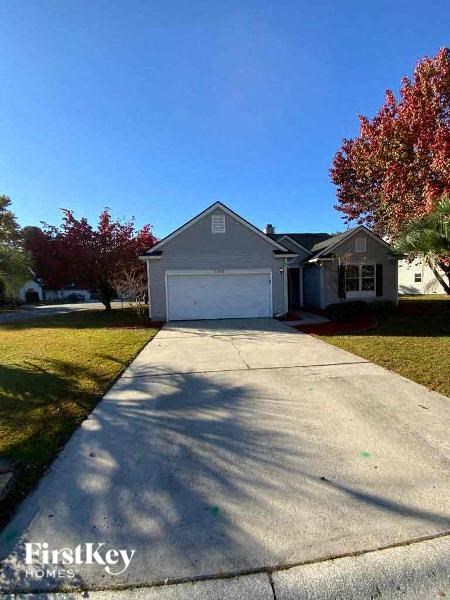 a driveway in front of a house with a white garage door