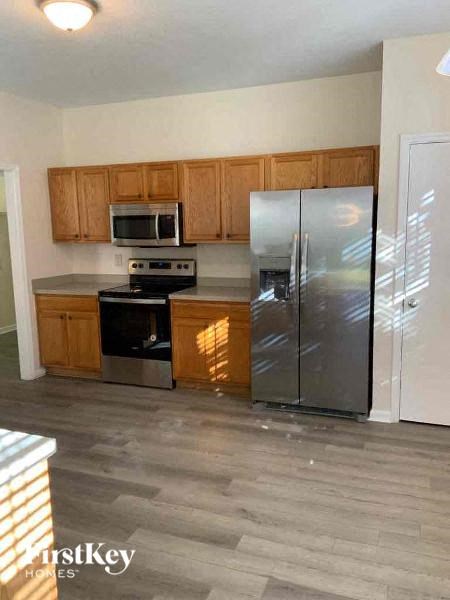 a kitchen with stainless steel appliances and wooden cabinets