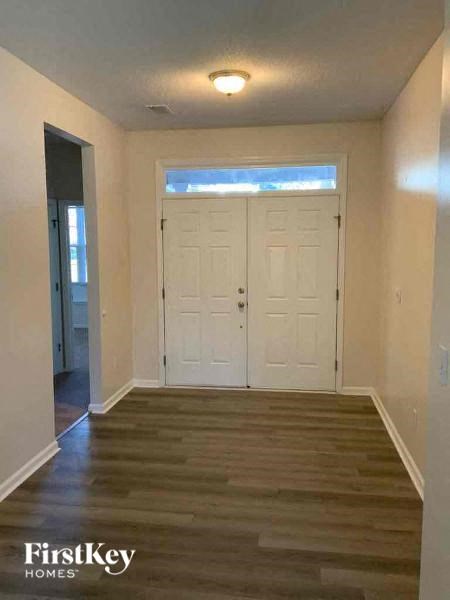 a empty room with a wood floor and white doors