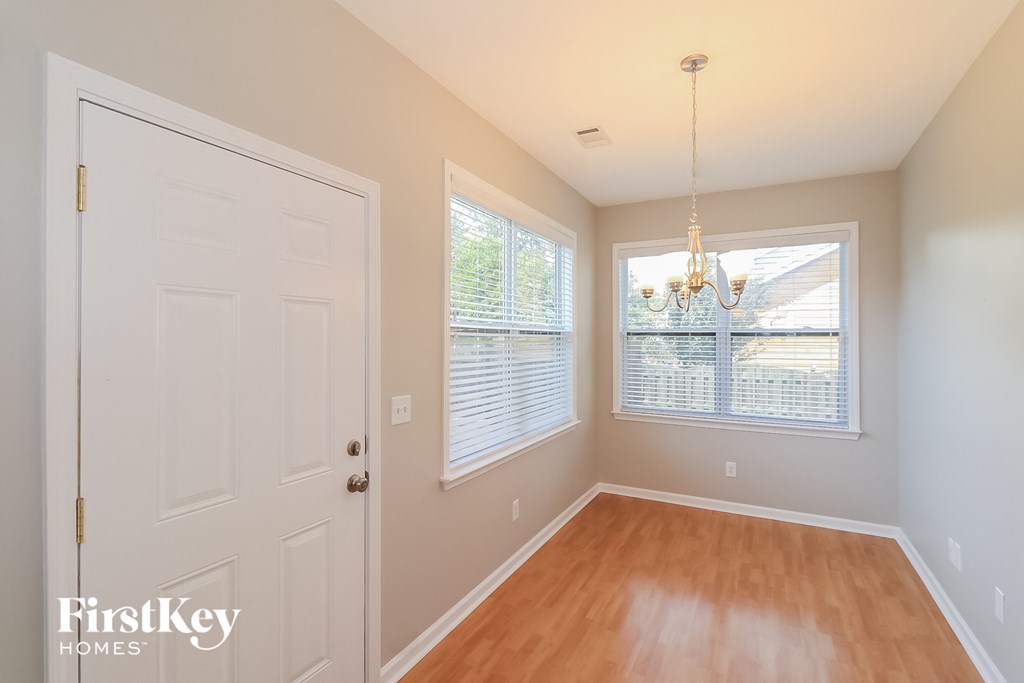 an empty room with a white door and a window