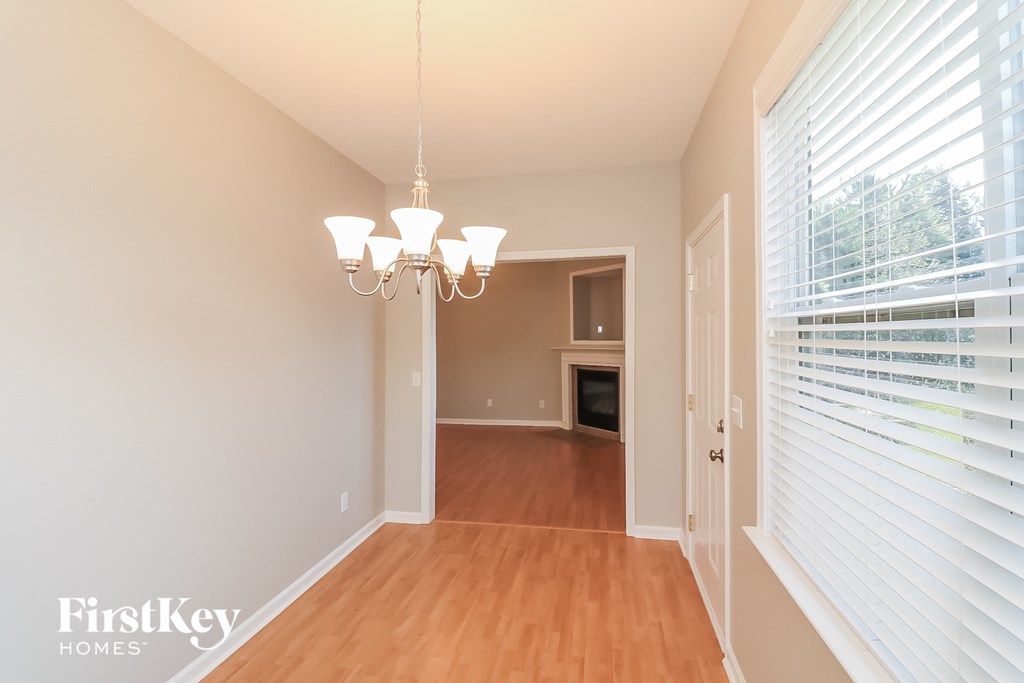 a dining room with wood flooring and a large window