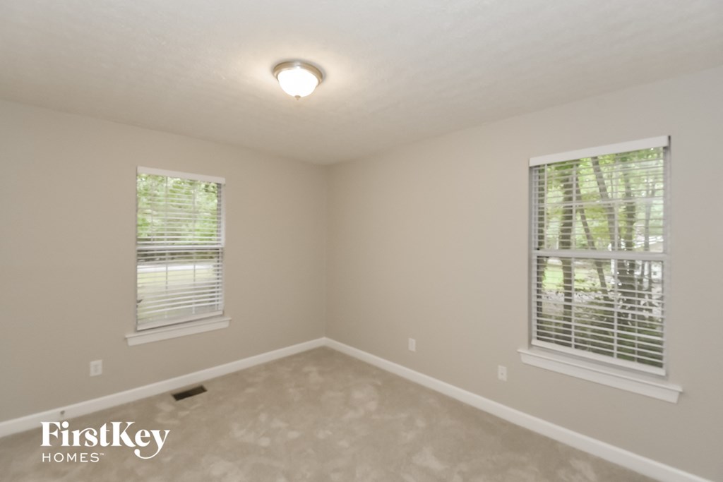 A room with a FirstKey Homes logo on the bottom left.