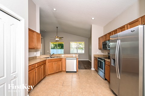 a kitchen with wooden cabinets and stainless steel appliances