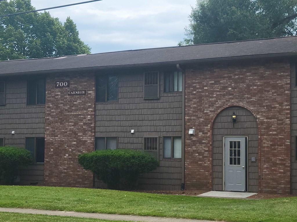 the front of a brick building with a blue door