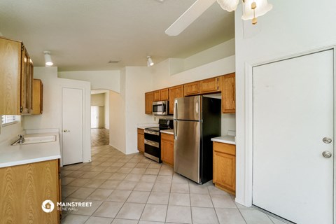 a kitchen with stainless steel appliances and wooden cabinets