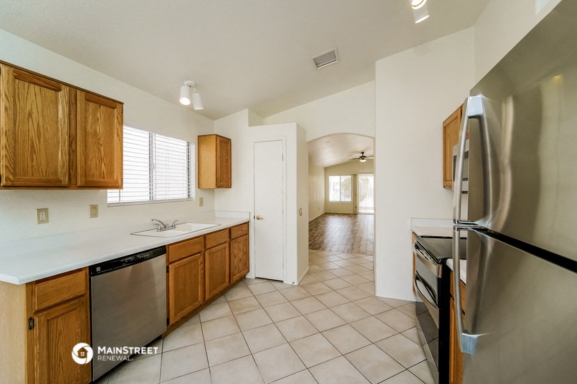 a kitchen with stainless steel appliances and wooden cabinets