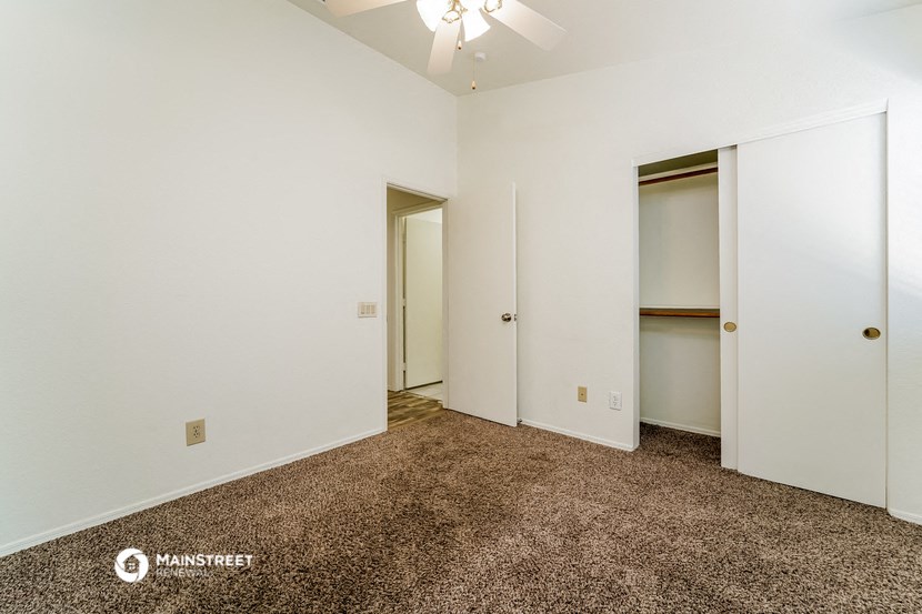 a bedroom with a carpeted floor and white walls