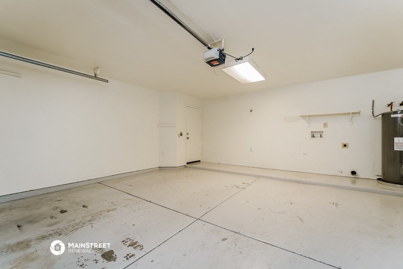 the living room of an empty room with white walls and a large white tile floor