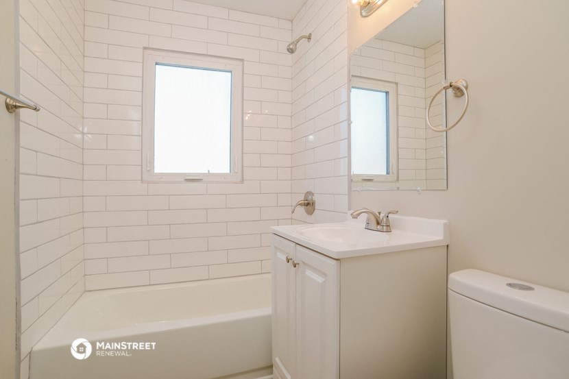 a bathroom with a sink and a bath tub and a mirror