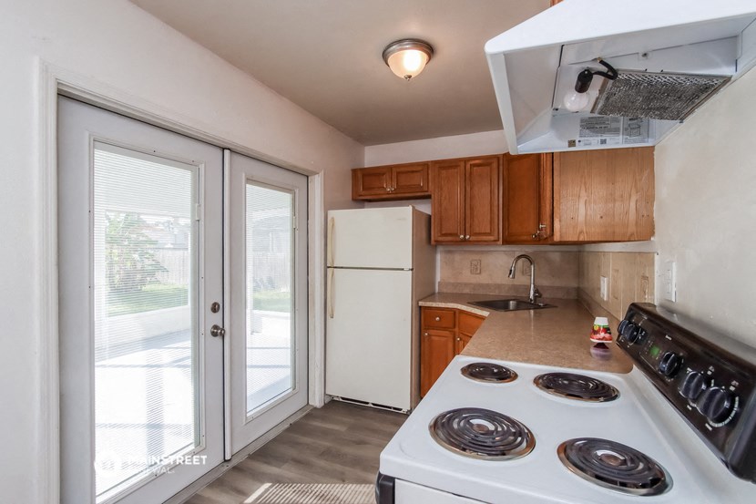 a kitchen with a white stove and a refrigerator