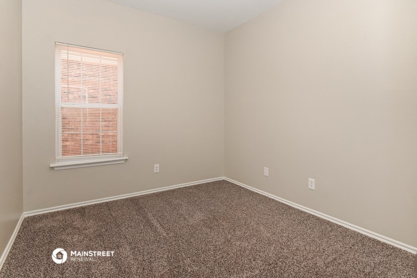 the upstairs bedroom has carpet and a window