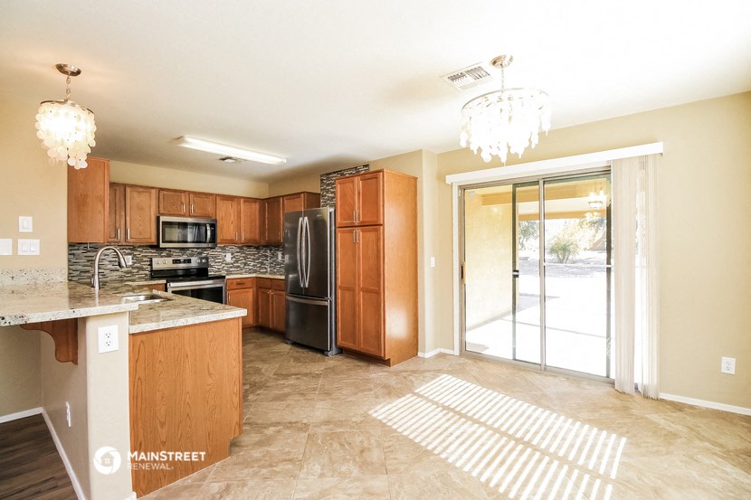 a kitchen with wood cabinets and stainless steel appliances