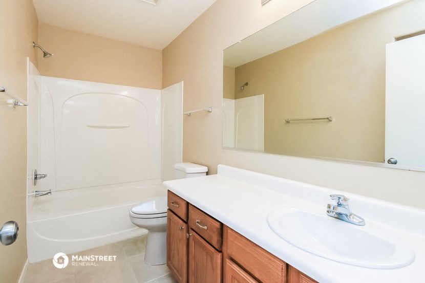 a bathroom with a sink and a toilet and a bath tub