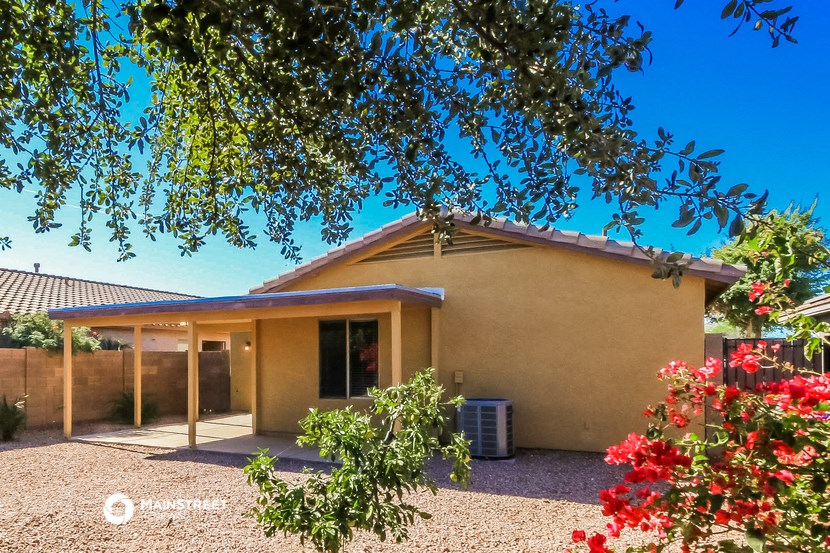 a small house with a yard and a tree