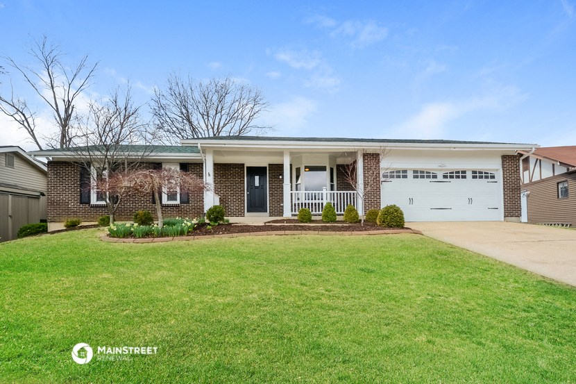 a house with a lawn and a white garage door