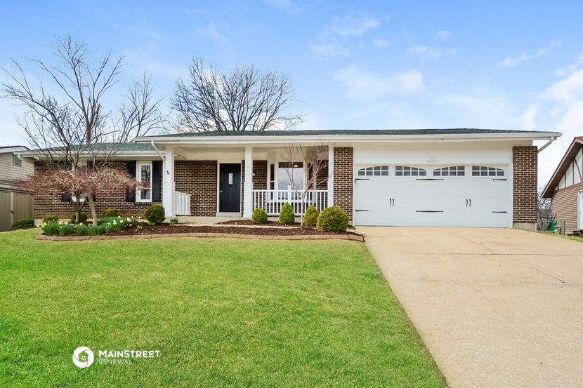a house with a white garage door and a lawn