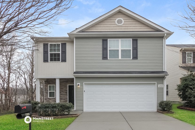 a gray house with a white garage door