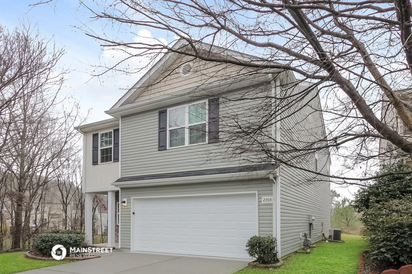 a gray house with a white garage door