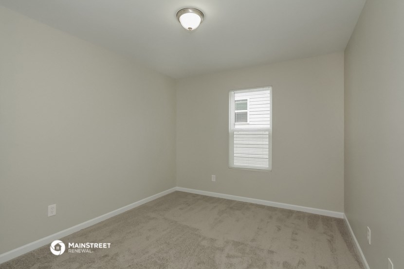 a empty room with white walls and a window