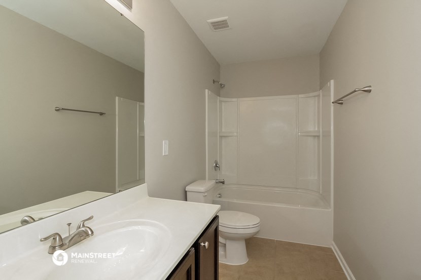 a bathroom with a sink and a toilet and a shower