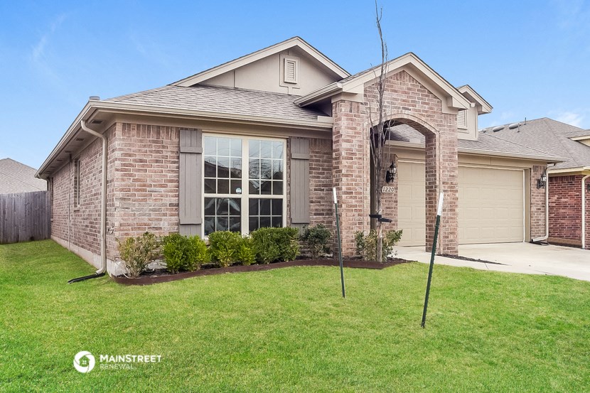 a brick house with a yard and grass