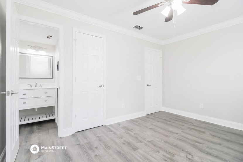 an empty bedroom with a closet and a bathroom