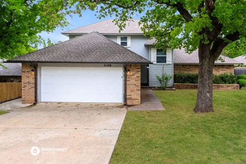 a white garage door in front of a house