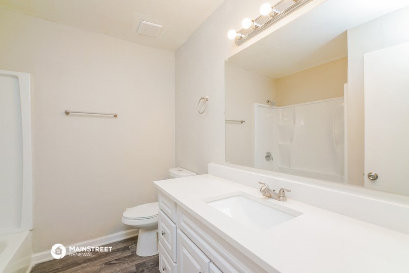 a white bathroom with a sink and a toilet