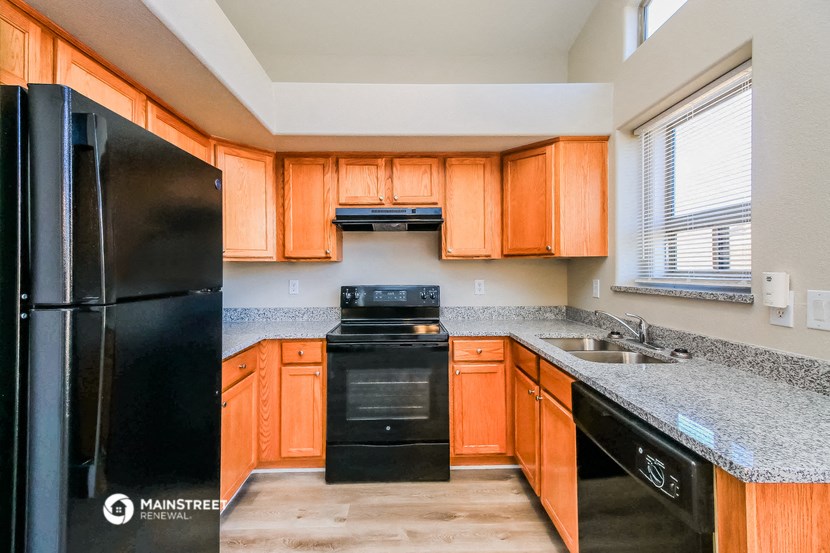 a kitchen with black appliances and granite counter tops