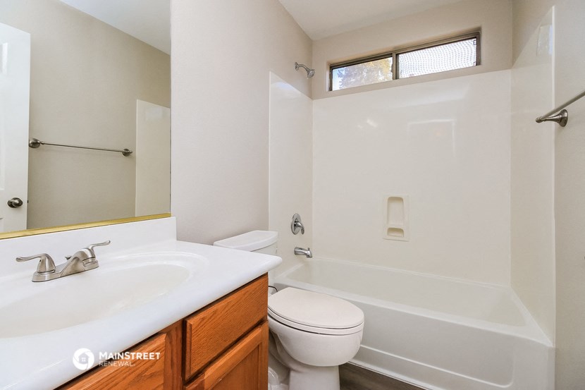 a bathroom with a sink toilet and a bath tub