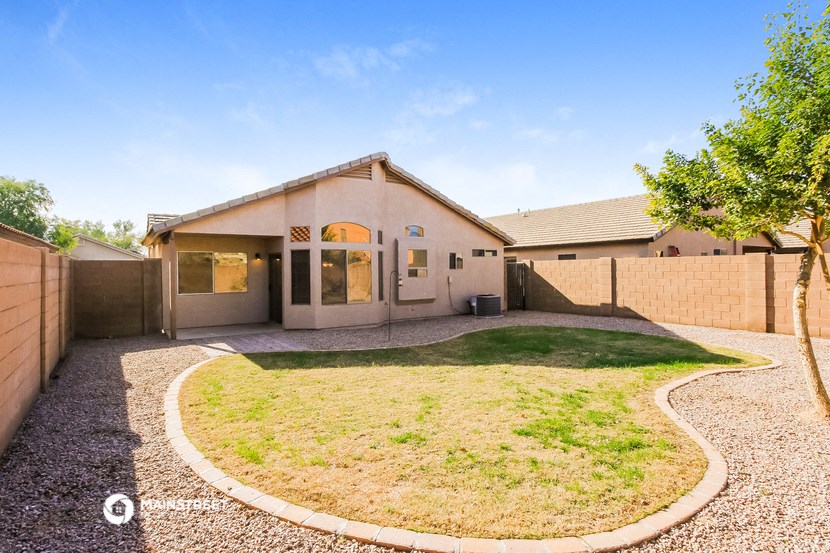 a house with a yard and a gravel driveway