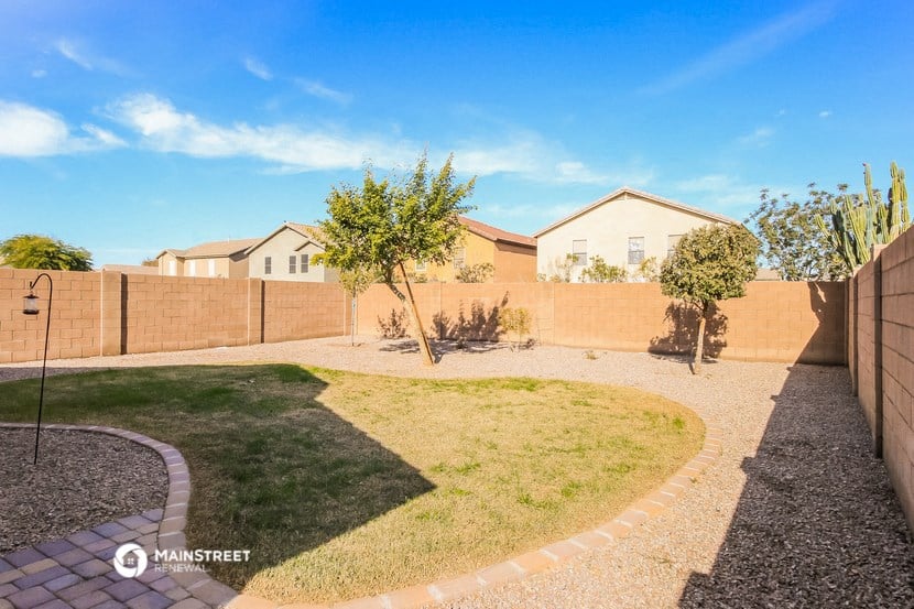 the backyard of a house with a yard and a fence