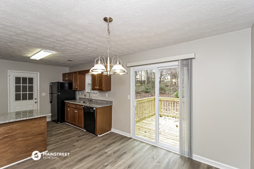 the kitchen is open to the deck and the living room