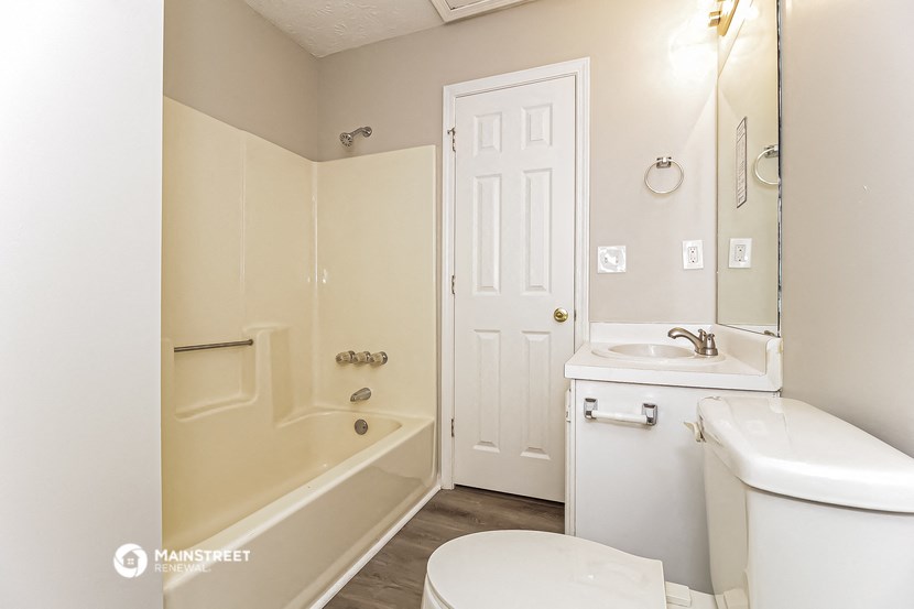 a bathroom with a sink toilet and a bath tub
