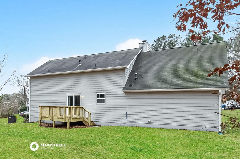 a white house with a porch and a gray roof
