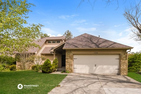 a house with a white garage door and a lawn