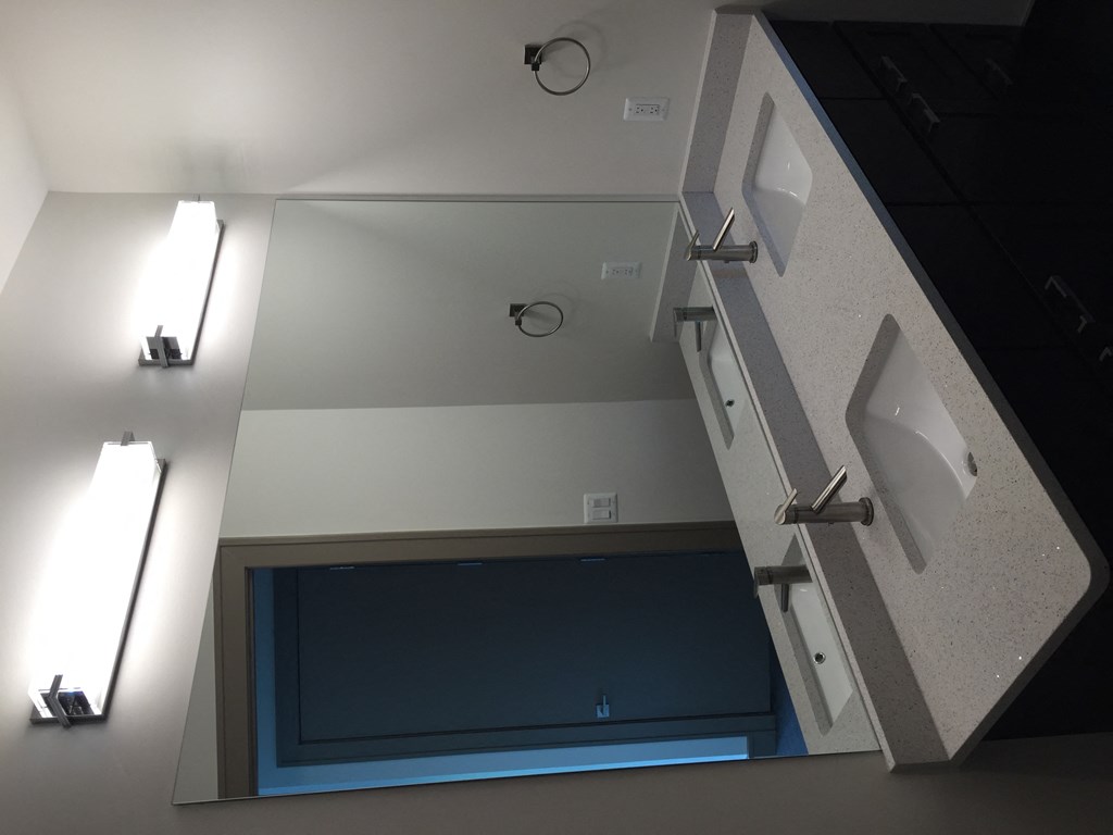 a bathroom with a mirror and a sink